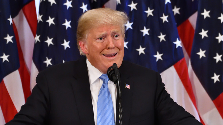 Trump at podium during press conference weird look on his face