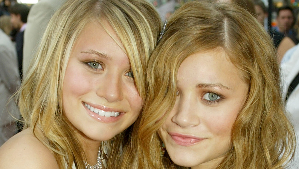 Mary-Kate and Ashley Olsen smiling at an event