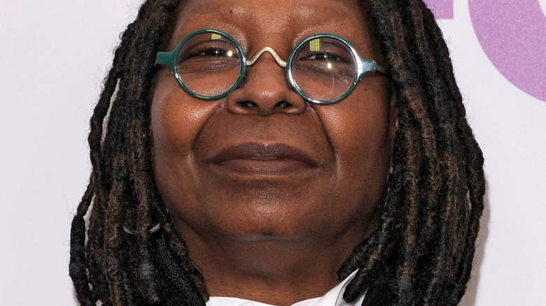 Whoopi Goldberg with slight smile and glasses