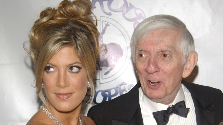 Tori Spelling with updo hair and dad Aaron Spelling