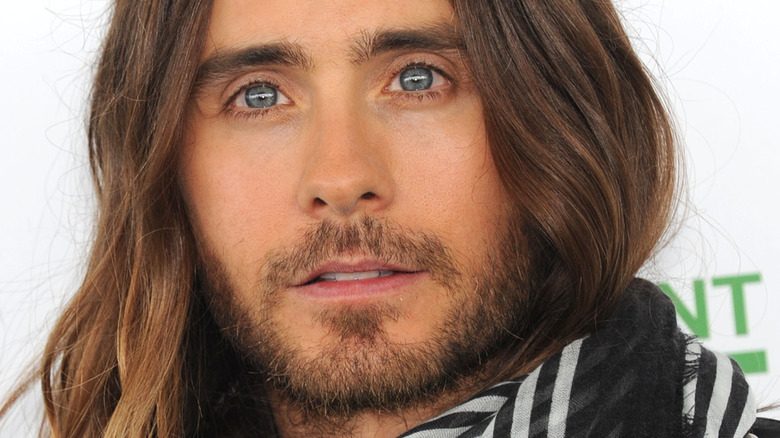 Jared Leto poses in a scarf
