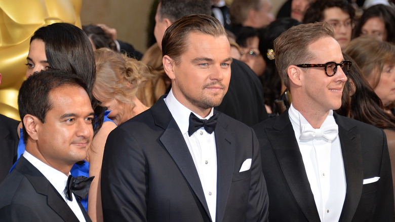 Riza Aziz, Leonardo DiCaprio, and Joey McFarland in suits at a 2014 award show