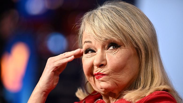 Roseanne Barr putting her hand to her head and making a face