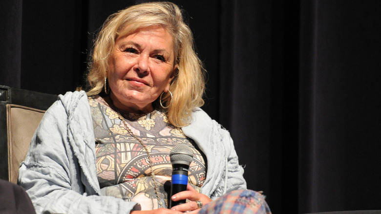 Roseanne Barr sitting with a microphone