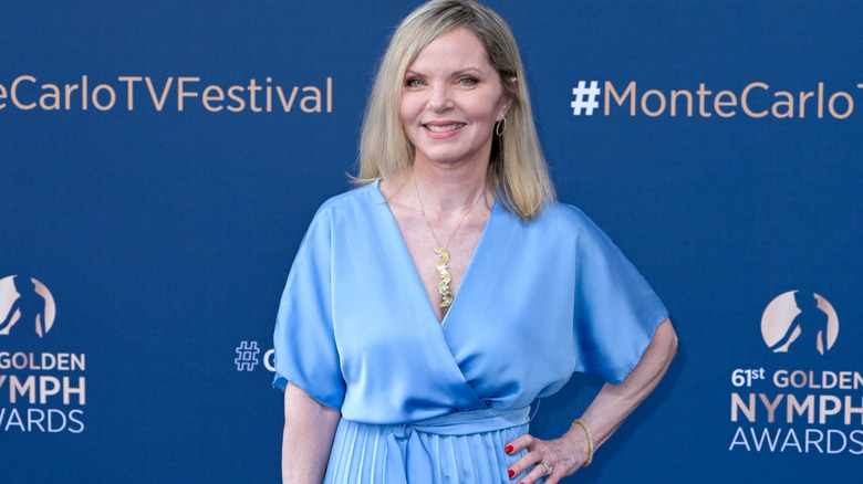 Melissa Sue Anderson smiling and posing with her hand on her hip.