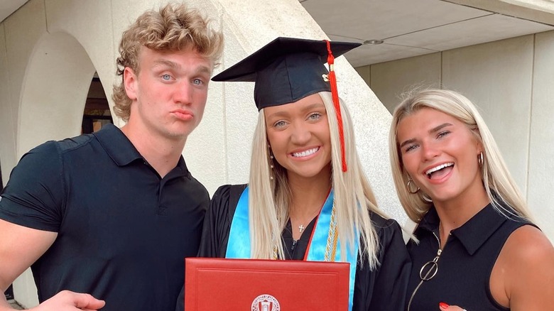 Wearing a graduation gown, Paige Drummond is all smiles in a group photo.