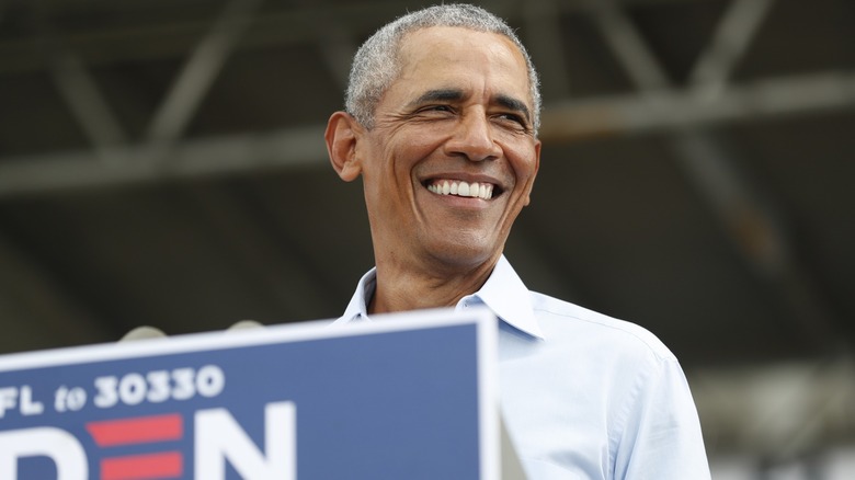 Barack Obama is all smiles in the podium at a Joe Biden-Kamala Harris rally.