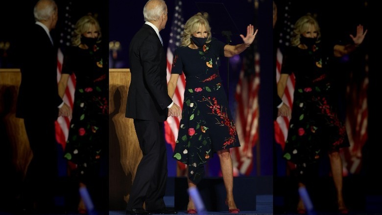 Jill Biden waving, holding President-elect Biden's hand