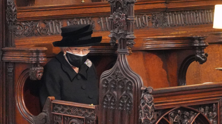Queen Elizabeth sits in a pew during Prince Philip's funeral