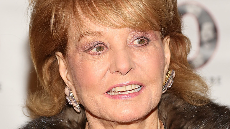 Barbara Walters wearing large earrings and fur coat