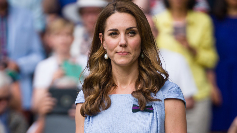 Kate Middleton smiling and wearing pearl earrings
