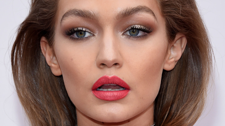 Gigi Hadid poses in red lipstick