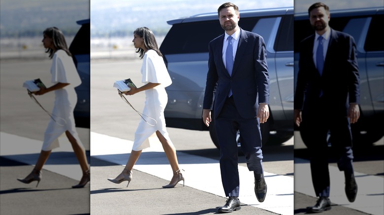 Usha and JD Vance walking in opposite directions on the tarmac.