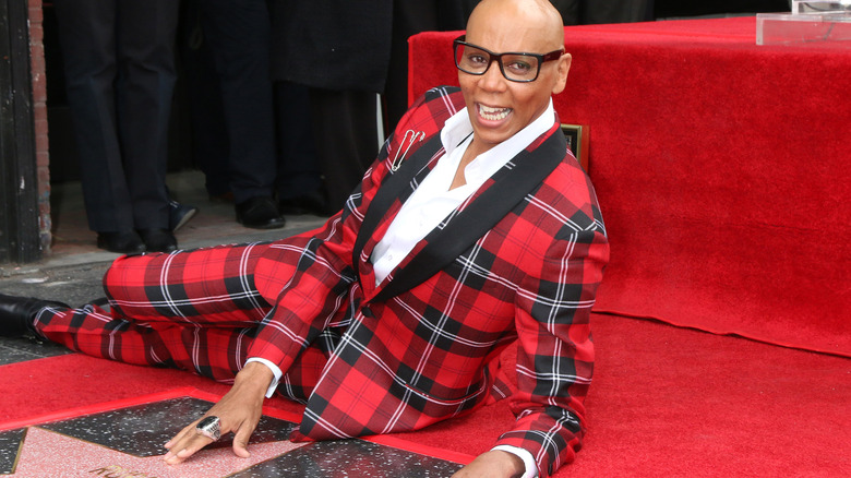RuPaul posing with his star