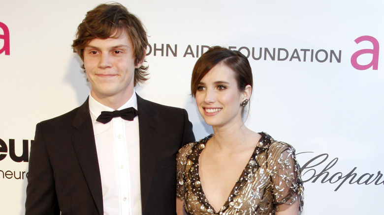 Evan Peters and Emma Roberts smile