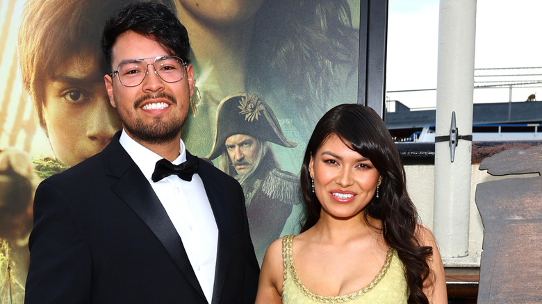 Alyssa Wapanatâhk smiling at posing for cameras with her husband.