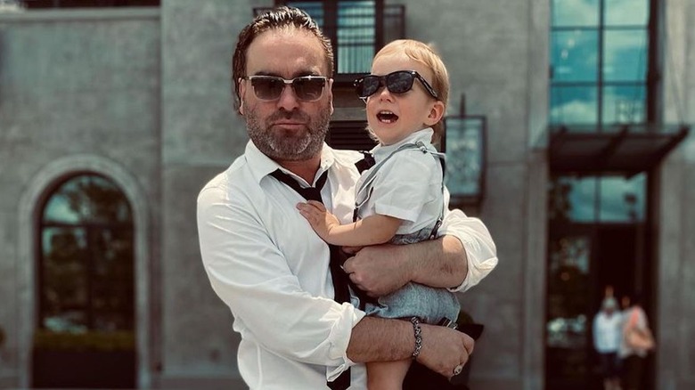 Johnny Galecki holding young son 