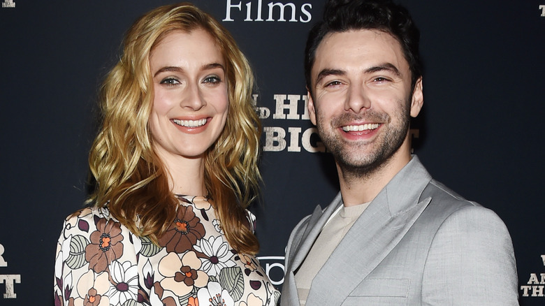 Caitlin Fitzgerald and Aidan Turner grinning 