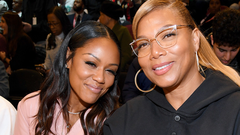 Eboni Nichols and Queen Latifah both seated and smiling