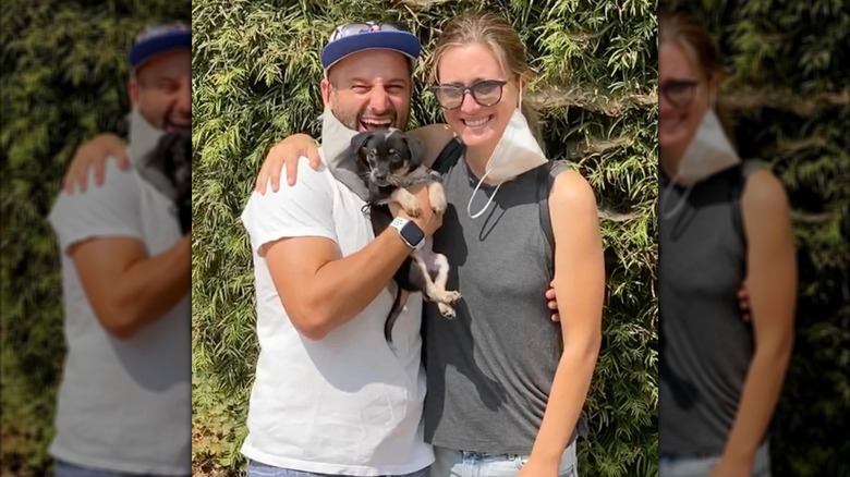 Zoe Perry and Gab Taraboulsy posing with their puppy, Unison.