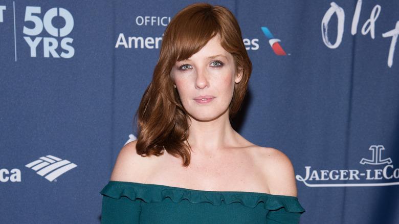 Kelly Reilly wearing off-the-shoulder green dress
