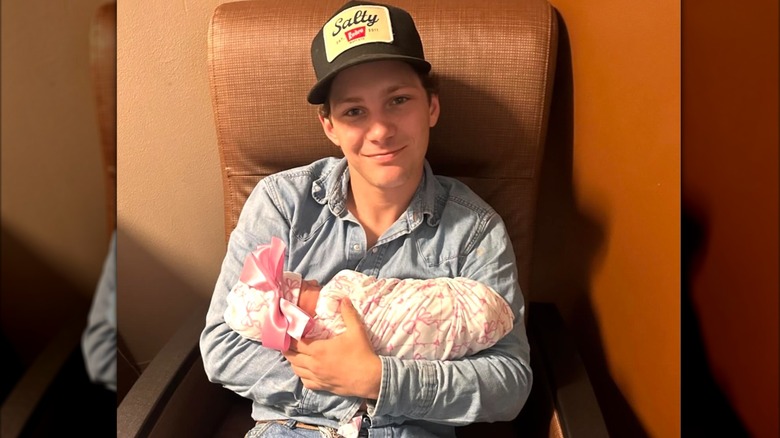 Montana Jordan holding his newborn daughter
