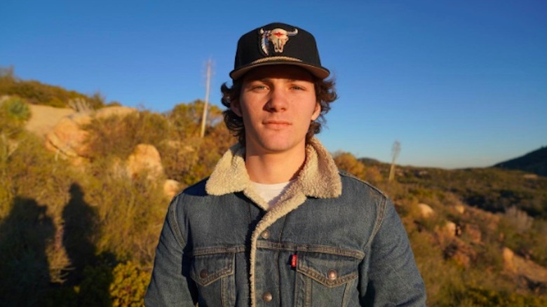 Montana Jordan posing outdoors, wearing a baseball cap