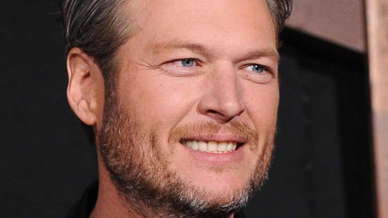 Blake Shelton smiles at an event