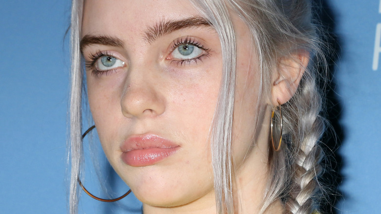 Billie Eilish with braided hair looking up