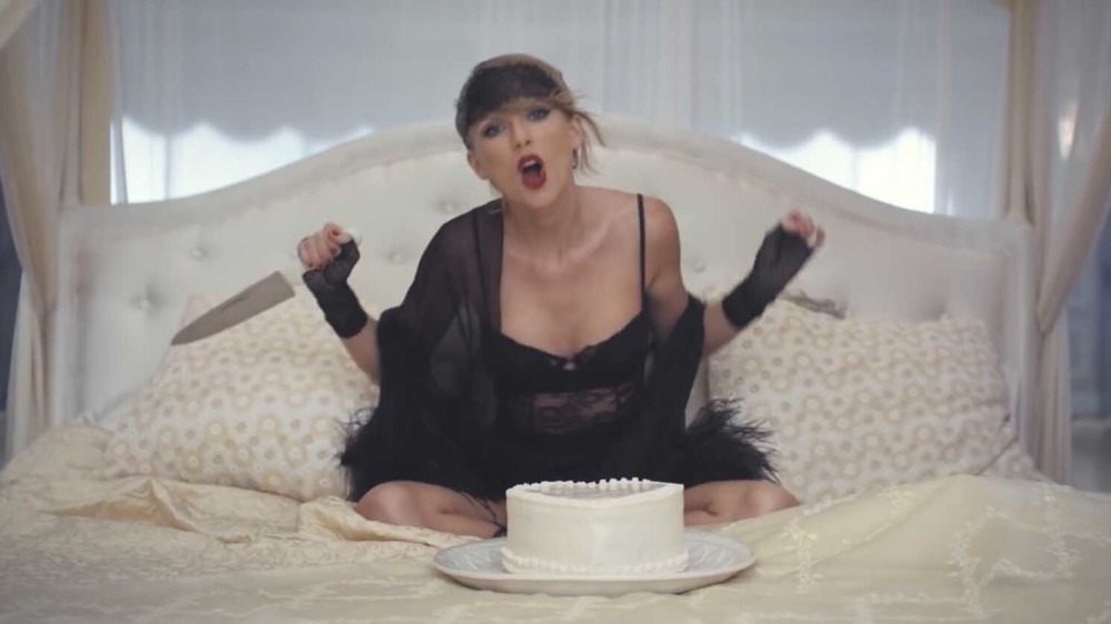Taylor Swift holding a knife on a bed in the music video for her song Blank Space