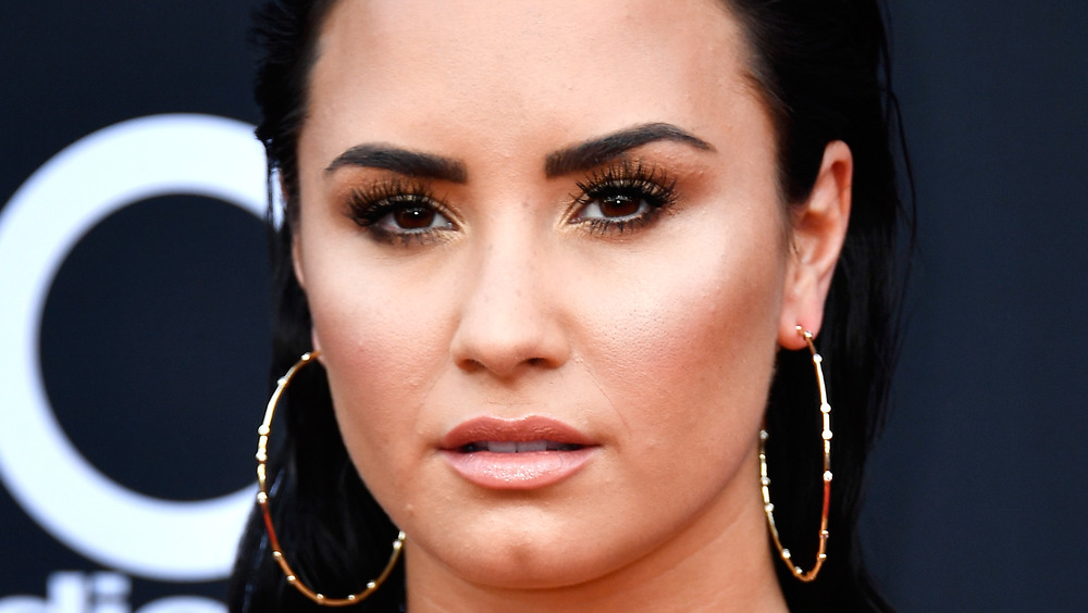 Demi Lovato with a serious expression