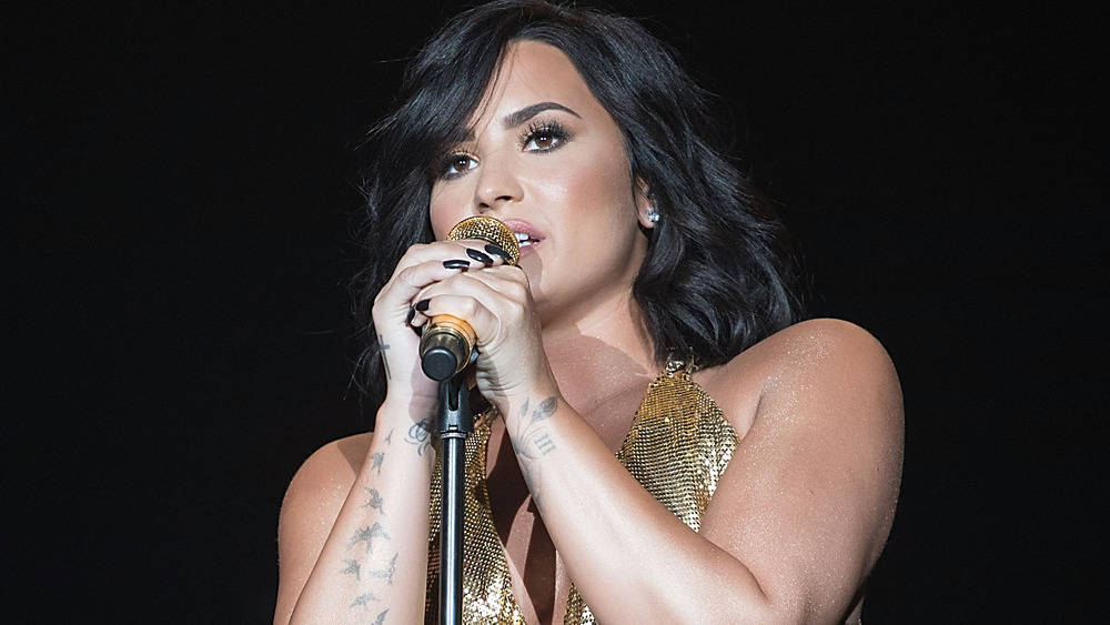 Demi Lovato singing on stage