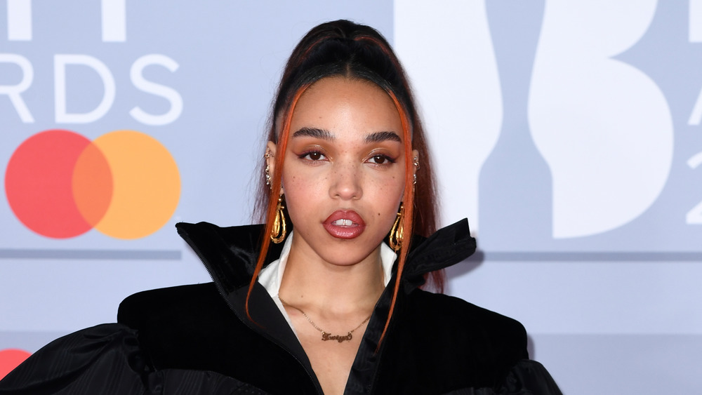 FKA Twigs posing on a red carpet