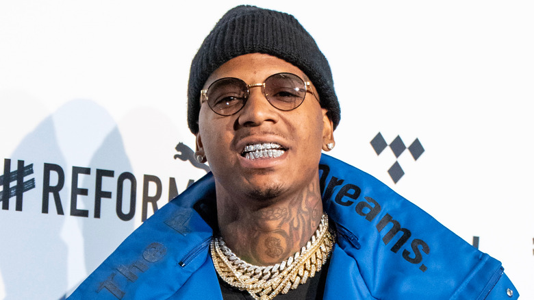 Moneybagg Yo smiles at an event