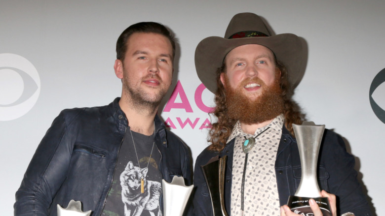 Brothers Osborne holding their music awards