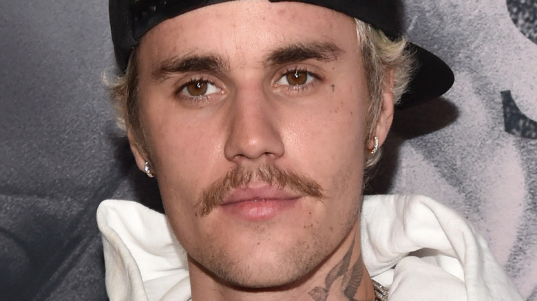 Justin Bieber backwards hat mustache