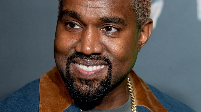 Kanye West smiling and looking to the side