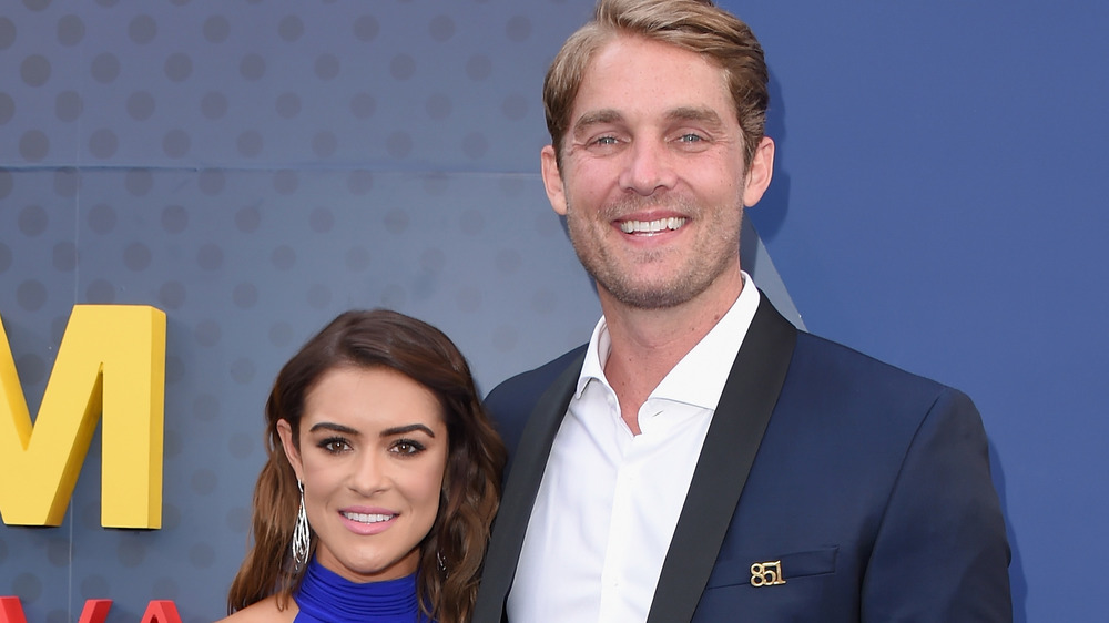 Taylor Mills and Brett Young posing on the red carpet