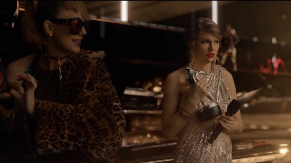 Taylor Swift dressed as different versions of herself side by side in her music video for Look What You Made Me Do