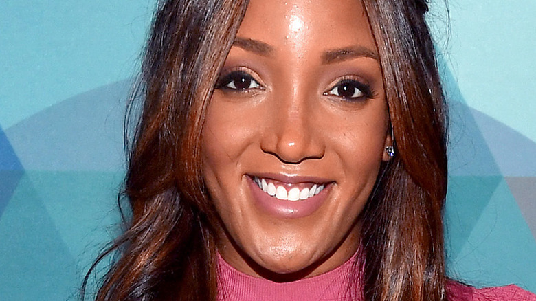 Mickey Guyton smiles on the red carpet