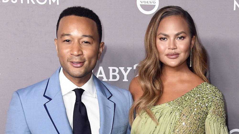 John Legend and Chrissy Teigen at an event 