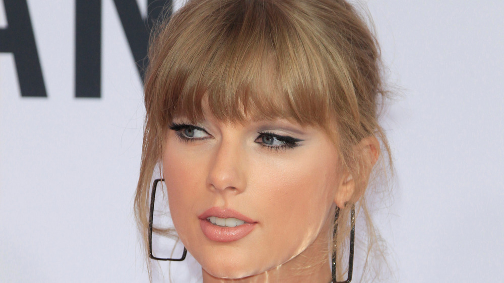 Taylor Swift gazes at the camera on the red carpet