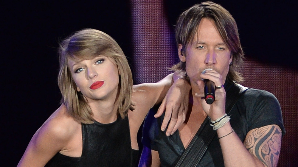 Taylor Swift and Keith Urban performing on stage