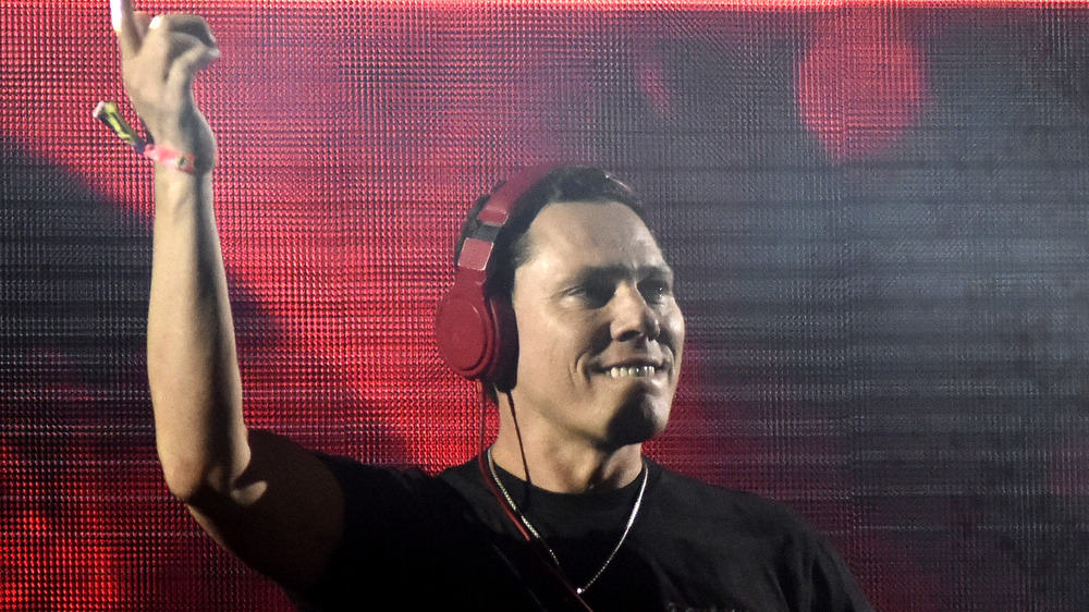 Tiesto DJs with headphones on