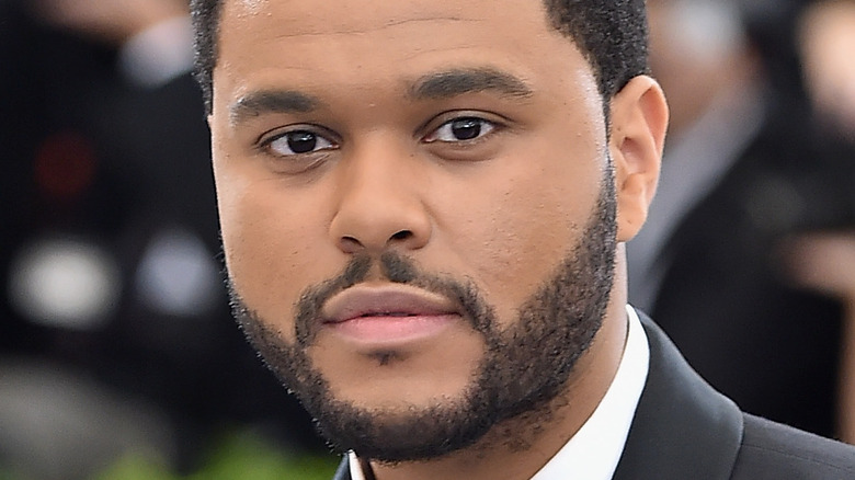 The Weeknd with a serious expression