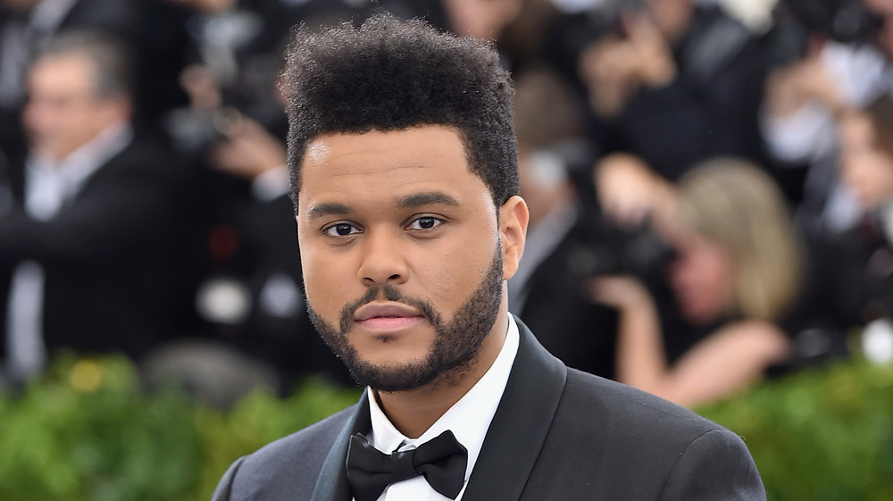 The Weeknd posing on red carpet