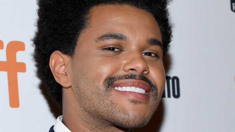 The Weeknd smirks on the red carpet