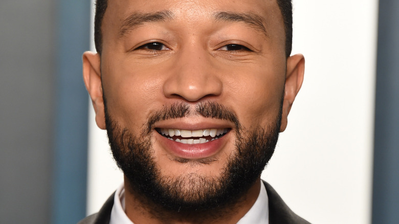 John Legend smiling at an event 