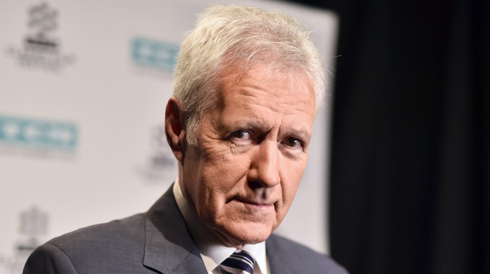 Alex Trebek looking at camera, not smiling