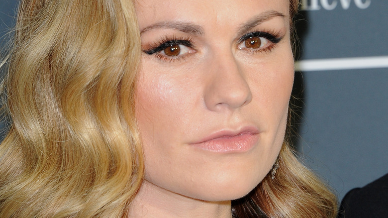 Anna Paquin with serious expression on red carpet 